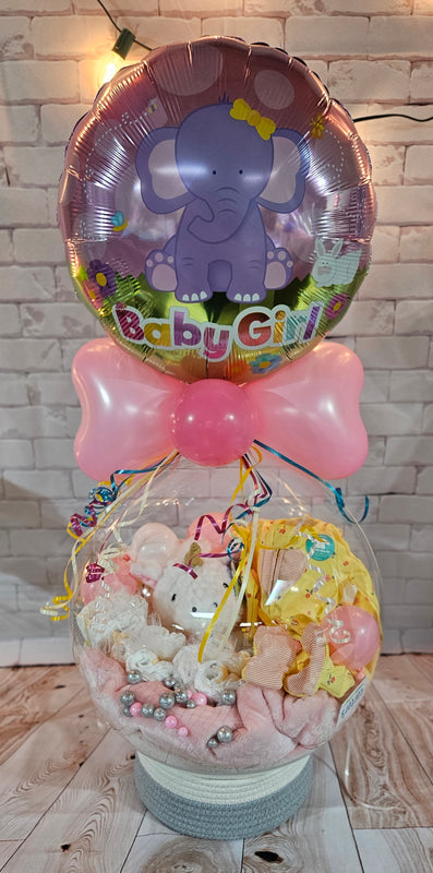 This upgraded Basic Balloon was designed as a thoughtful baby shower gift. It included a fabric basket base, a cozy minky blanket, a soft sensory plush animal from our Gift Center, a sweet little onesie, and festive ribbon.