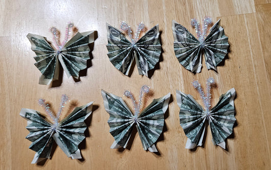 Add three origami butterflies made from currency bills to Balloon Box. Customer will provide currency.